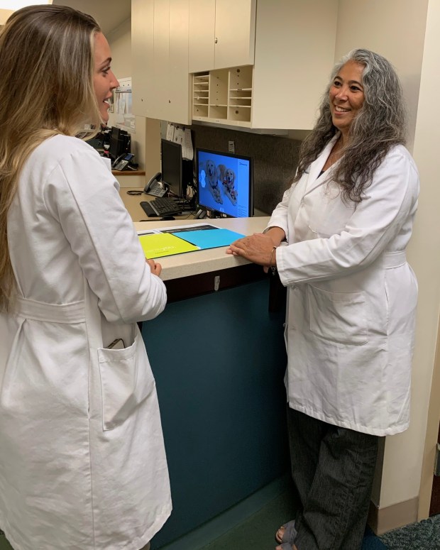 Lillian Craggs-Dino, a registered dietitian at Cleveland Clinic Weston, consults with her colleague Claudia Rivera. They work with patients undergoing weight-loss treatment to develop a long-term diet.