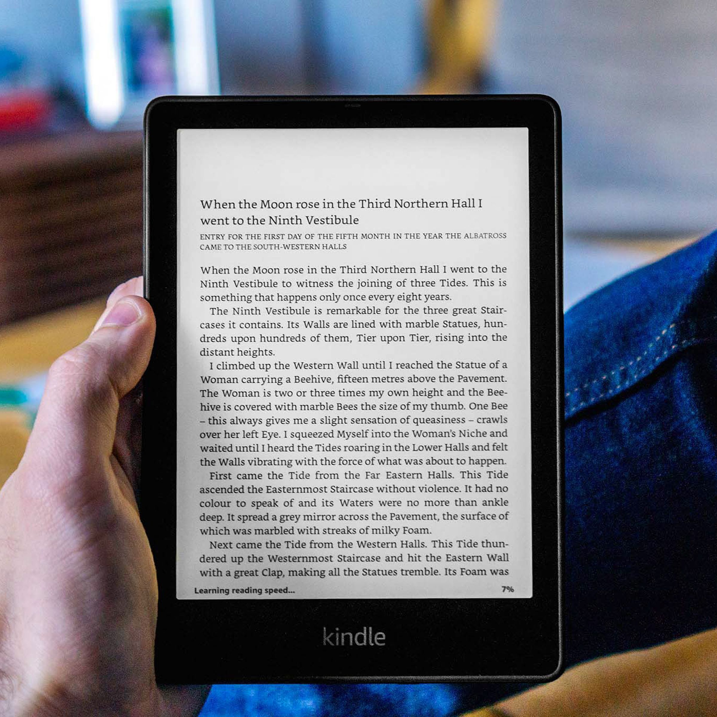 A hand holding the Kindle Paperwhite