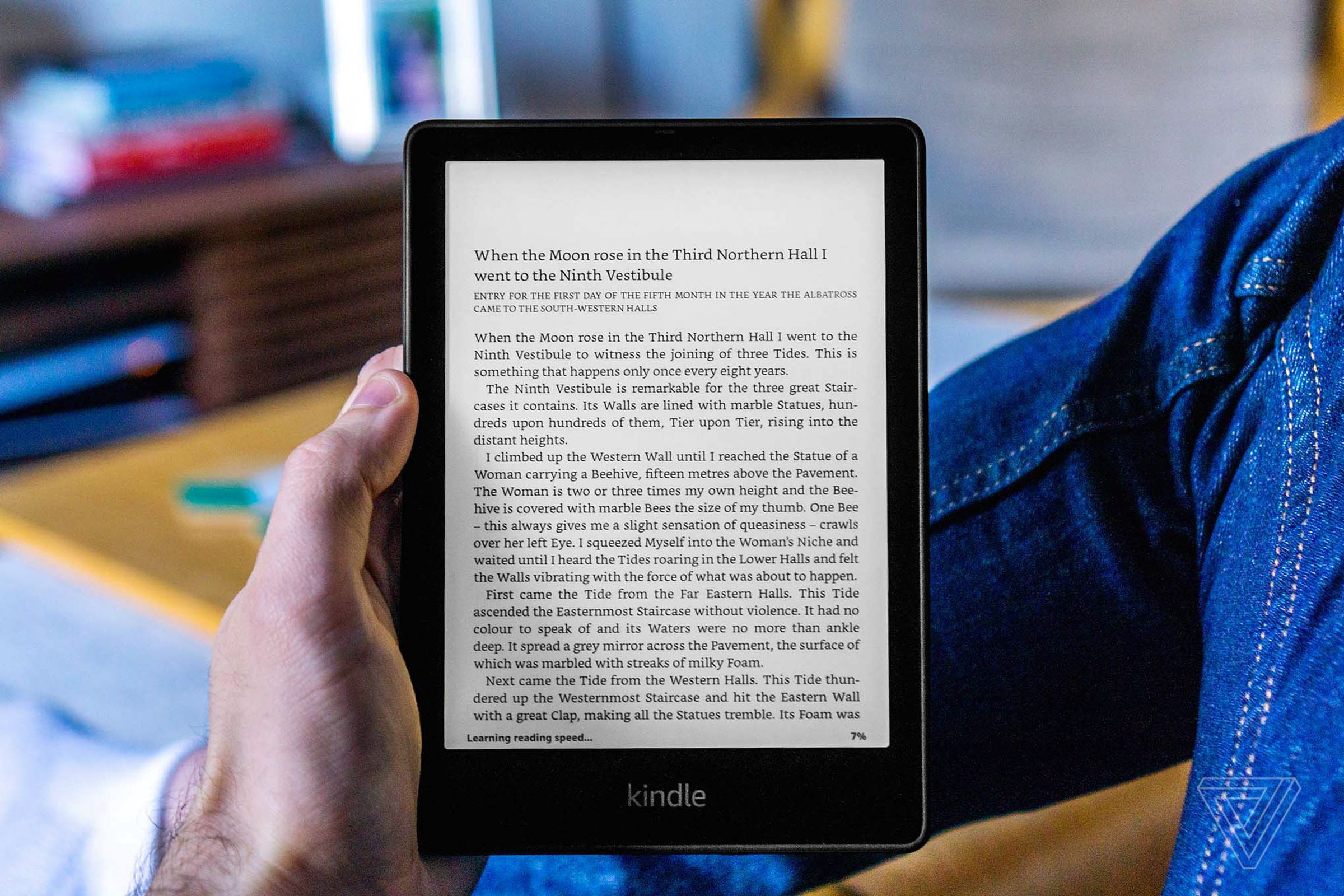 A hand holding the Kindle Paperwhite