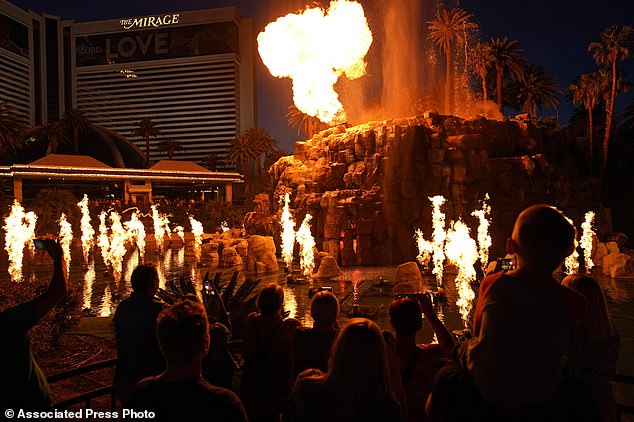 People watch the volcano show at the Mirage on May 13, 2022