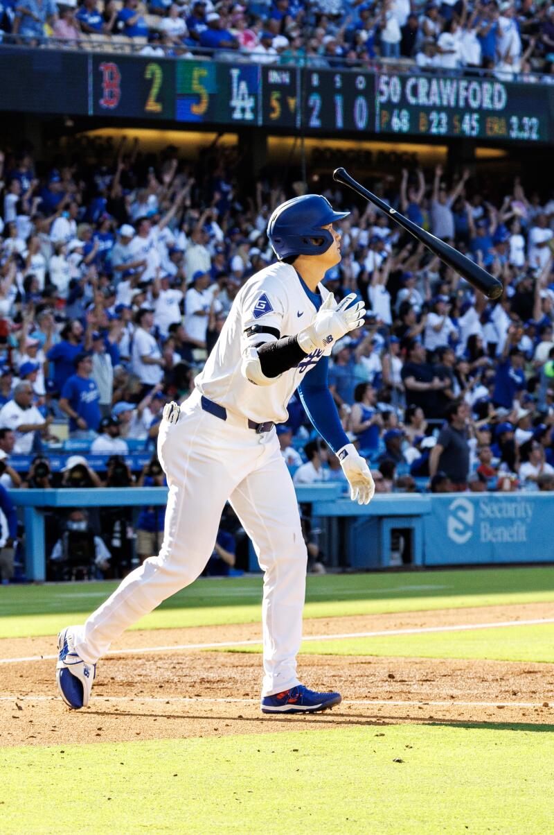 Dodgers star Shohei Ohtani throws his bat after hitting a 473-foot home run at Dodger Stadium.