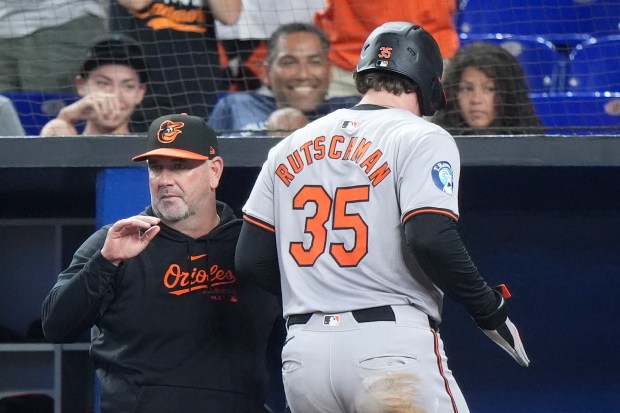 Baltimore Orioles' Adley Rutschman (35) is congratulated by manager Brandon...