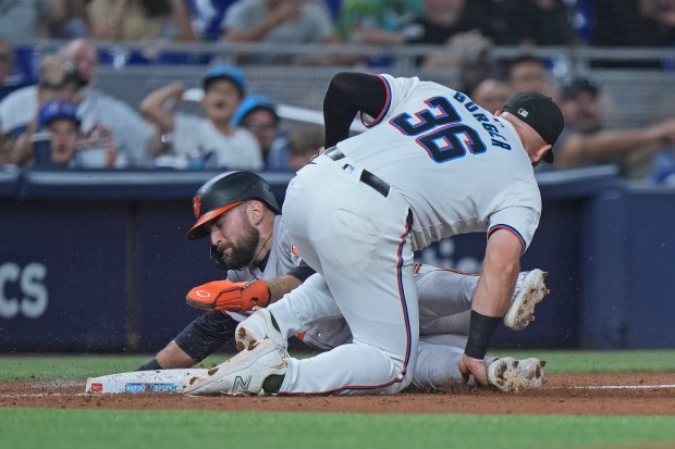 Miami Marlins third baseman Jake Burger (36) tags Baltimore...