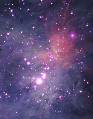 hazy pink and purple areas of space, speckled with numerous points of light.