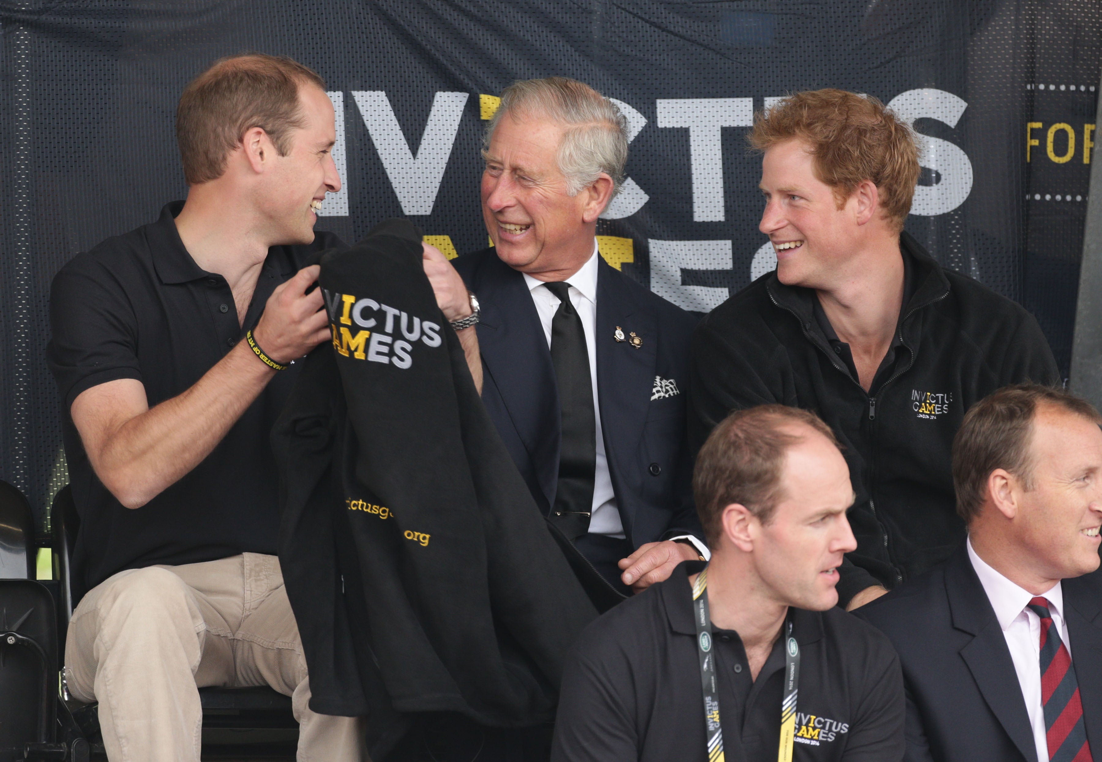 William, Charles and Harry share a joke while watching the athletics events at the Invictus Games in 2014 (Yui Mok/PA)