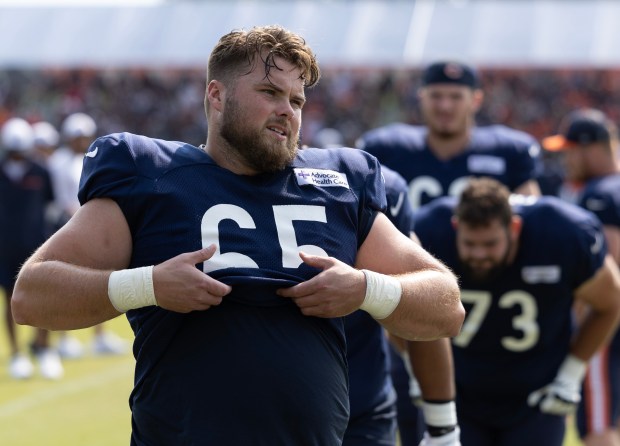 Bears center Coleman Shelton airs out his jersey during a practice with full protection at training camp on July 26, 2024, in Lake Forest. (Stacey Wescott/Chicago Tribune)