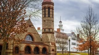 A photo of old brick buildings in the fall on the Dartmouth campus