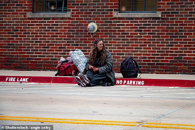 Today, about 1,400 people in the city experience homelessness each night. Pictured: A homeless woman sits on a sidewalk in Oklahoma City in 2019