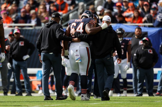 Bears guard Nate Davis is helped off the field during the first quarter against the Vikings on Oct. 15, 2023, at Soldier Field.