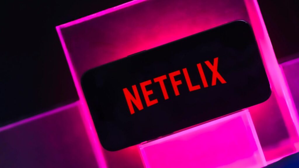 Netflix logo in a pink box surrounded by black background