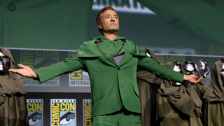 Robert Downey Jr. dressed as Doctor Doom holding a mask in his right hand