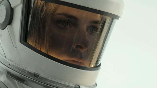 A woman appears in a spacesuit. 