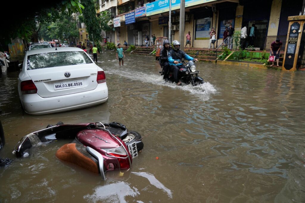 Across the river, opposite a lavish Indian wedding, frustration and flooded streets