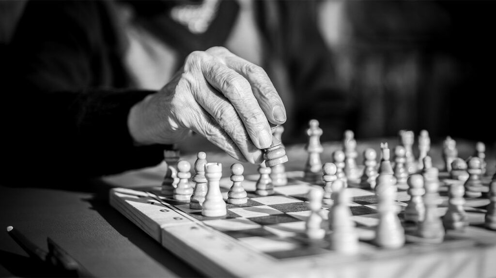 Close-up of an elderly person playing chess