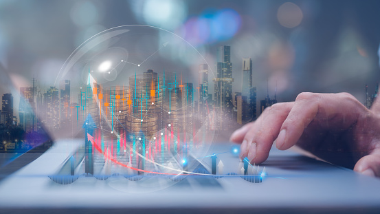 investment and finance concept, businessman using computer working on virtual trading chart and blurred coins in bubble on hand, stock market, business profit and growth