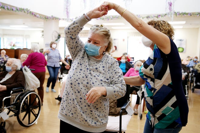 Residents and staff gather during an Easter concert for vaccinated residents at Ararat Nursing Facility on April 1, 2021 in Los Angeles. The concert was the first social event held at the facility since the start of the pandemic.