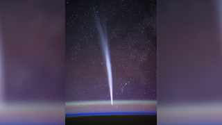 A bright fuzzy streak can be seen oriented up and down on an image of the starry sky