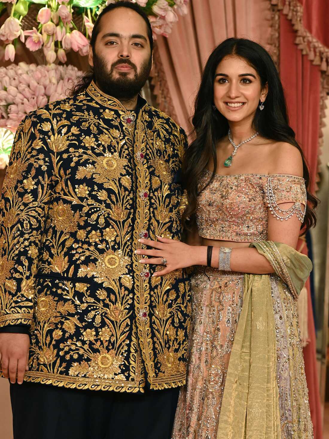 Anant Ambani, son of billionaire tycoon and Reliance Industries Chairman Mukesh Ambani (unseen) with his fiancee Radhika Merchant pose for a picture during their Sangeet ceremony in Mumbai, on July 5, 2024. (Photo by SUJIT JAISWAL / AFP) (Photo by SUJIT JAISWAL/AFP via Getty Images)