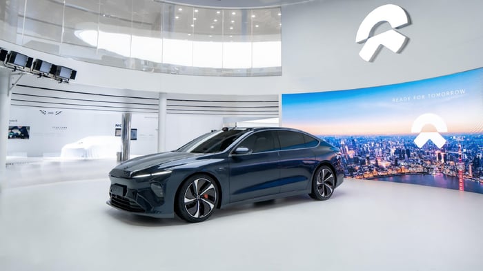 A fully electric Nio ET7 sedan on display in a showroom.