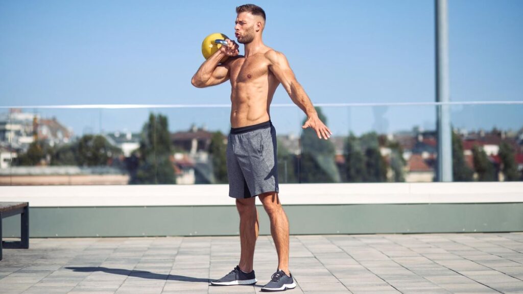 a man performing a kettlebell workout outside