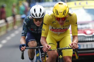 Slovenian rider Tadej Pogacar of UAE Team Emirates wearing the yellow jersey of the general classification leader and Danish rider Jonas Vingegaard of Team Visma - Lease a Bike ride the final kilometers of the 11th stage of the 111th edition of the Tour de France cycling race, 211 km between Évaux-les-Bains and Le Lioran, in the Massif Central mountains of central France, on July 10, 2024. (Photo by Anne-Christine POUJOULAT / AFP)