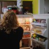 Annalise and Ellie Currence stand in front of the refrigerator deciding on dinner at their home in Belton, Missouri, on July 17.