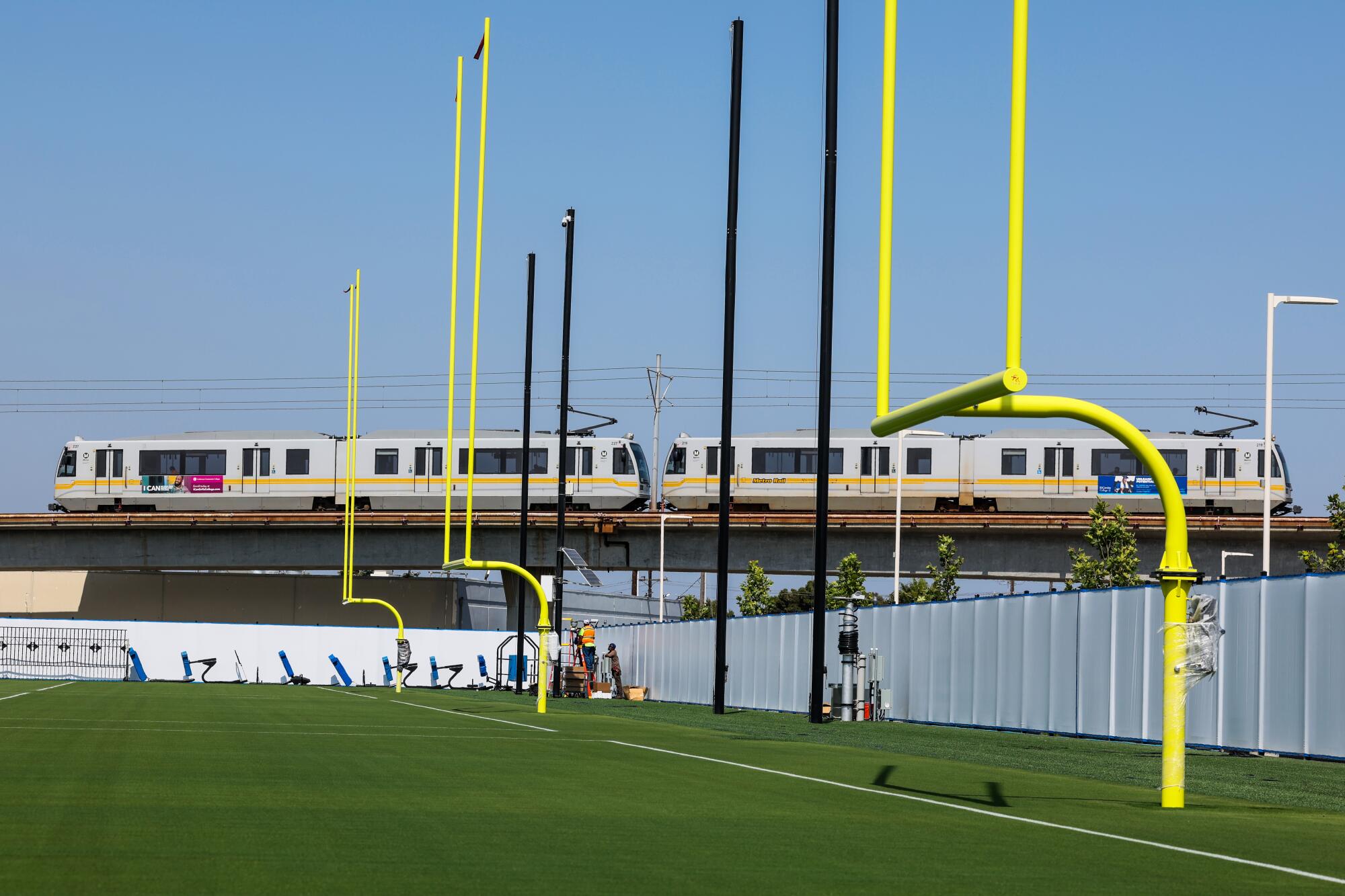 A train passes the Chargers' practice field.