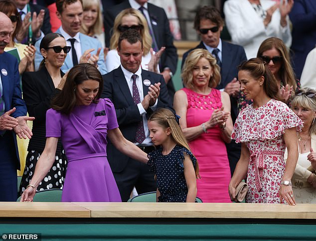 As Charlotte and the Princess of Wales arrived to take their seats in the royal box at Centre Court, the couple were greeted with a standing ovation and loud applause.