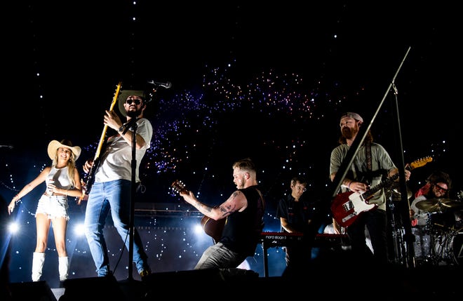 Hailey Welch, far left, joined Zach Bryan onstage as he performed at Nissan Stadium in Nashville, Tenn., on Saturday, June 29, 2024.