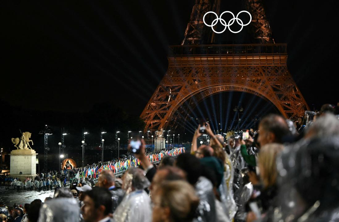 Flags of participating countries are carried across the Pont d'Iéna during the opening ceremony of the Paris 2024 Olympic Games in Paris on July 26, 2024. (Photo by Jonathan NACKSTRAND / AFP) (Photo by JONATHAN NACKSTRAND/AFP via Getty Images)