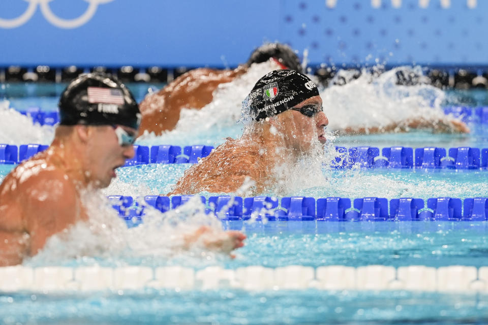 Nicolo Martinenghi of Italy, center, competes in the men's 100-meter breaststroke final at the 2024 Summer Olympics, Sunday, July 28, 2024, in Nanterre, France. (AP Photo/Martin Meissner)