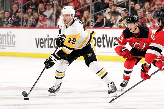 NEWARK, NJ - APRIL 2: Reilly Smith #19 of the Pittsburgh Penguins controls the puck in front of Jesper Bratt #63 of the New Jersey Devils during the third period at Prudential Center on April 2, 2024 in Newark, New Jersey. The Penguins won 6-3.