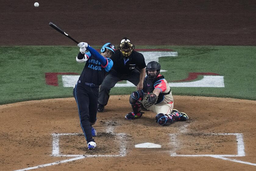 Los Angeles Dodgers National League player Shohei Ohtani hits a home run during the third inning of the MLB All-Star Game, Tuesday, July 16, 2024, in Arlington, Texas. Jurickson Profar of the San Diego Padres and Ketel Marte of the Arizona Diamondbacks also scored. (AP Photo/LM Otero)