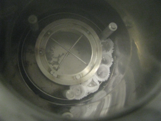 The experimental samples are loaded into the specially designed Dewar which will be filled with liquid nitrogen shortly after and placed under gamma radiation. Note that the flame-sealed test tubes are wrapped in cotton cloth to hold them together as the test tubes become buoyant in the liquid nitrogen and begin to float in the Dewar, interfering with proper radiation exposure.