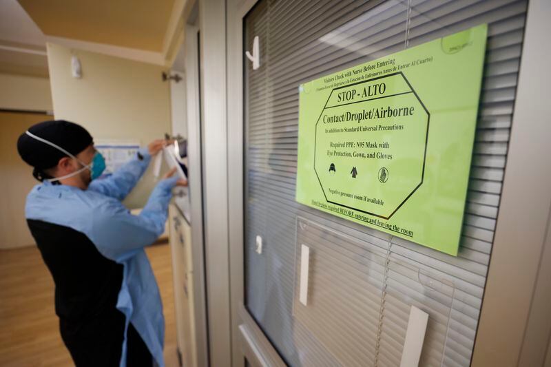 COVID-19 continues to pose a threat, especially to medically vulnerable people, including older adults. A sign advises medical staff and visitors to take precautions before entering rooms with COVID-19 patients at Northeast Medical Georgia Center in Gainesville, Ga., Monday, Feb. 5, 2024. Miguel Martinez /miguel.martinezjimenez@ajc.com