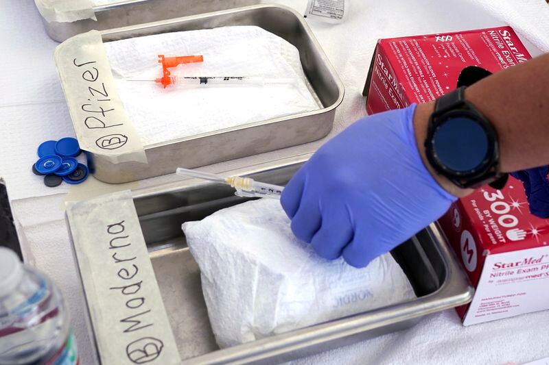 In this file photo, syringes containing vaccines are prepared at the LA Care and Blue Shield of California Promise Health Plans Community Resource Center. (AP Photo/Mark J. Terrill, File)