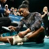 American gymnast Simone Biles appeared to injure her left leg during a warm-up on Sunday, but she completed the remaining events after wrapping her ankle with thick athletic tape.