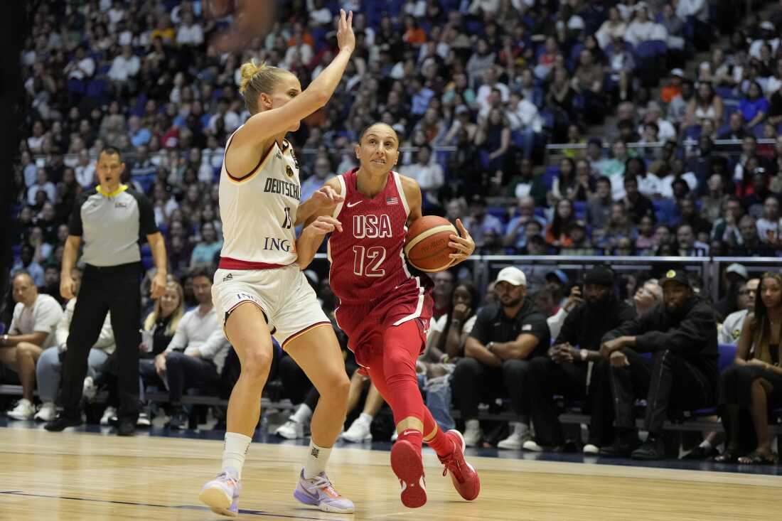 American Diana Taurasi (R) shoots past German Leonie Fiebich during a women's basketball exhibition match between the United States and Germany in London on July 23, 2024.